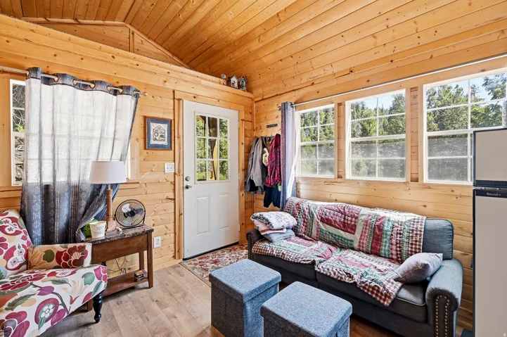 Interior space featuring natural wood paneling throughout, a vaulted wood-plank ceiling, and wood-finish flooring