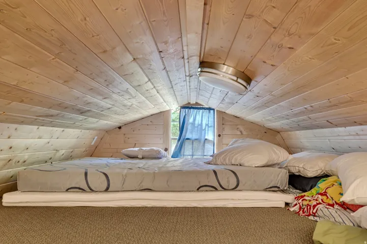 Wood-paneled sloped ceiling with integrated flush-mount lighting