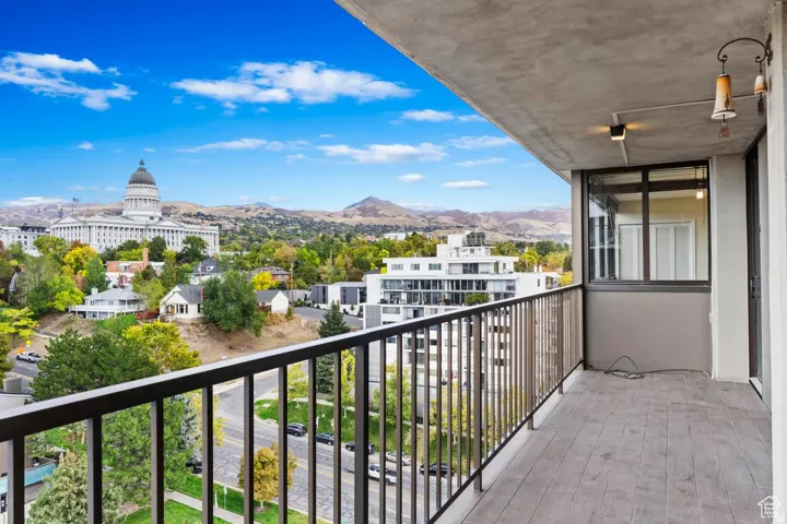 Spacious balcony with composite decking and black metal railings