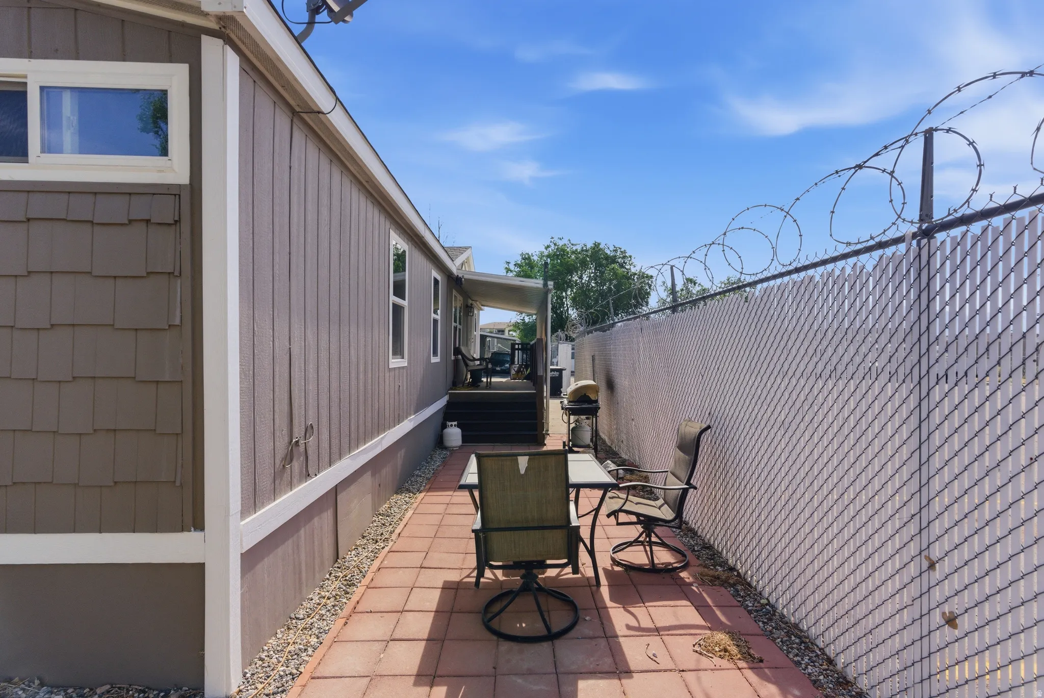 Outdoor patio featuring terracotta-colored pavers and a gravel border