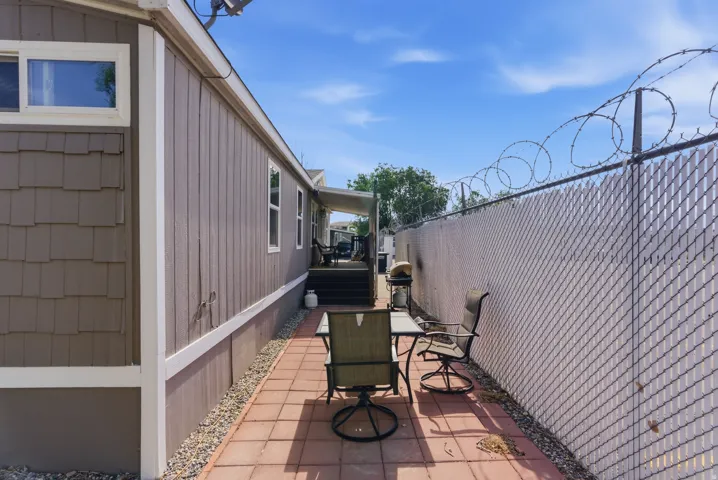 Outdoor patio featuring terracotta-colored pavers and a gravel border
