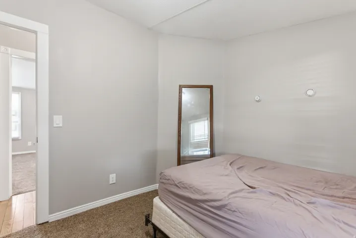 Wall-to-wall carpeting with light gray walls and white trim
