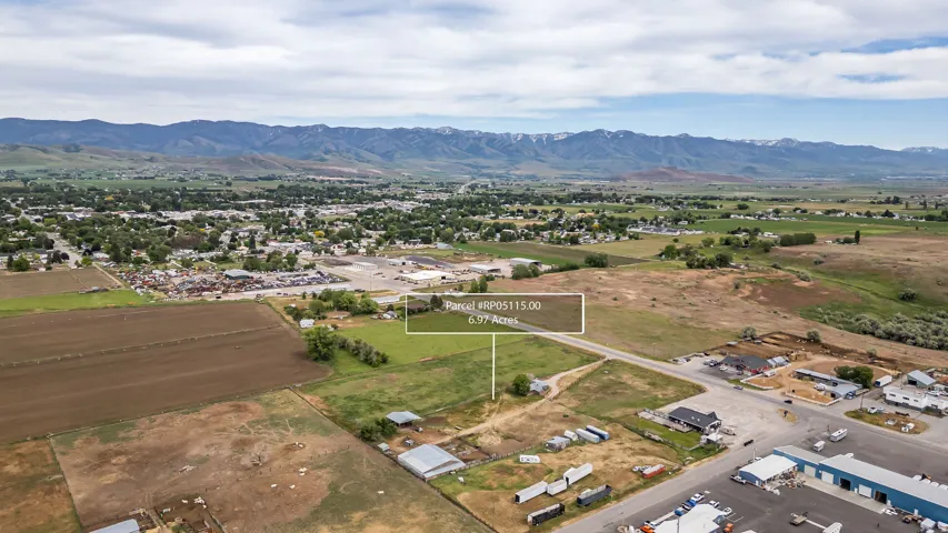 Expansive land parcel encompassing 6.97 acres, featuring a combination of cleared and grassy areas