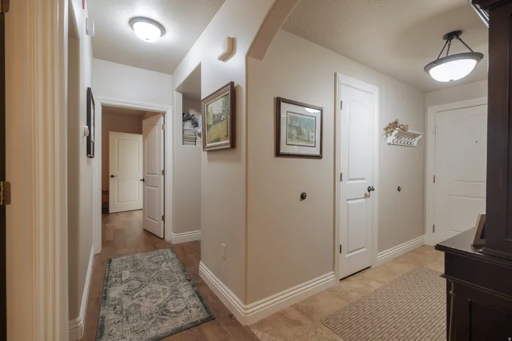Hallway featuring wood-finish flooring and neutral wall tones