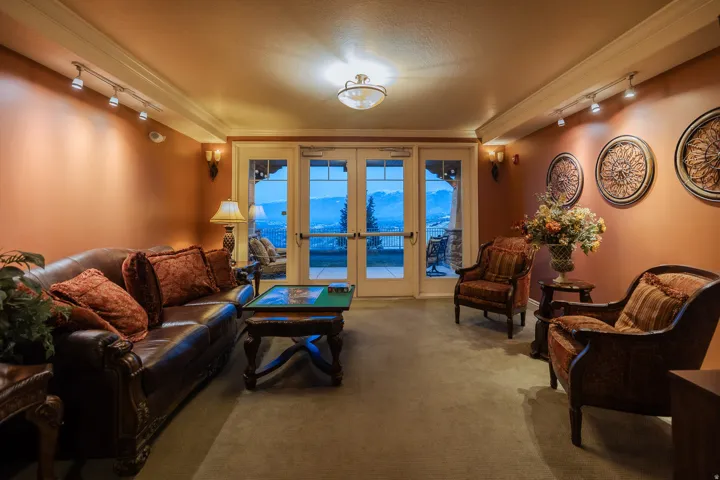 French doors with transom windows lead to an outdoor space