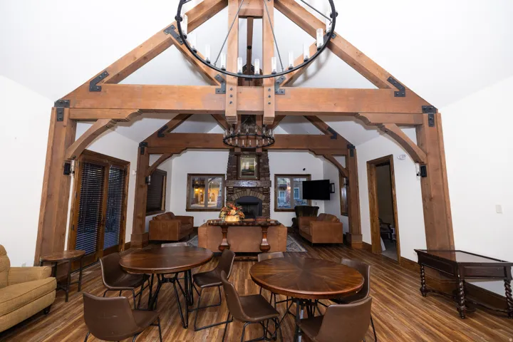 Vaulted ceiling with exposed wood beams and metal accents