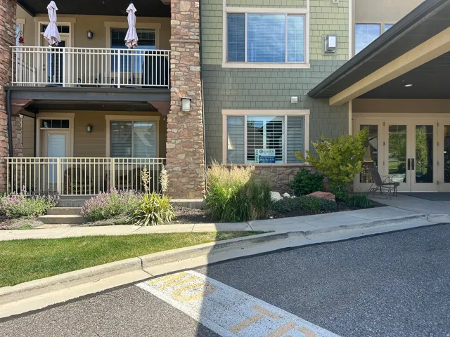 Multi-level exterior featuring stone veneer accents, shake siding, and a covered main entrance