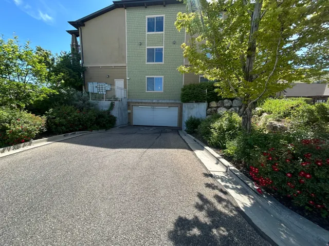Multi-story exterior with light green horizontal siding and beige stucco accents