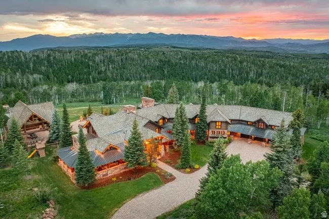 Expansive property with a multi-gabled roofline and stone exterior accents