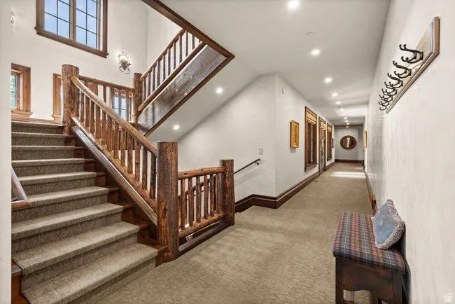 Central staircase featuring rustic wood log newel posts and railings
