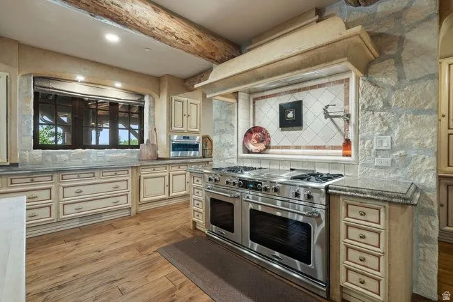 Gourmet kitchen with a professional-grade stainless steel range, double ovens, and a pot filler faucet