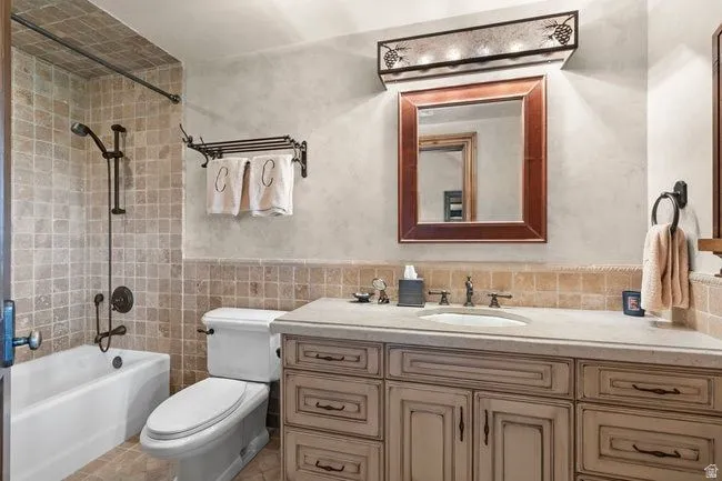 Bathroom featuring a single vanity with stone countertop, integrated sink, and an oil-rubbed bronze faucet