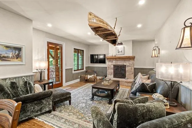 Stone-clad fireplace with wood mantle