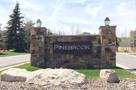 Stone-clad monument sign featuring integrated lanterns