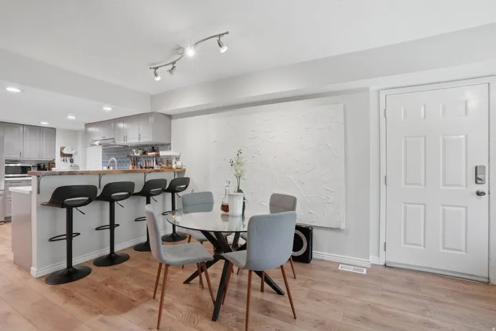 Open-concept kitchen and dining area featuring wood-finish flooring