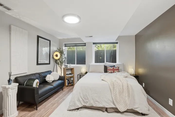 Room featuring wood-finish flooring, recessed lighting, and two windows with blinds