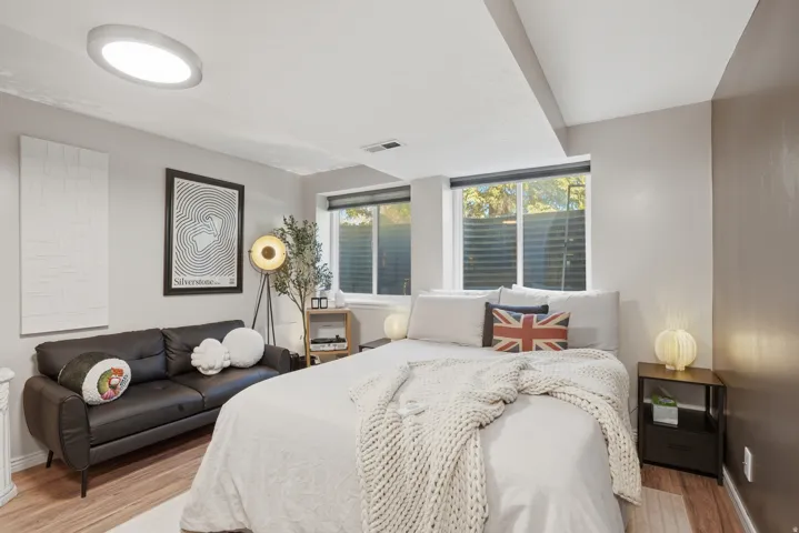 Room featuring wood-finish flooring, recessed lighting, and two windows with blinds