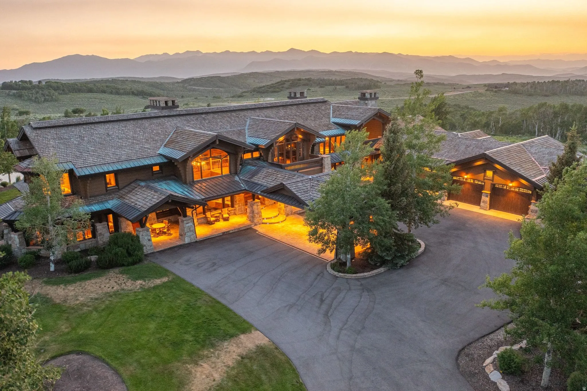 Expansive mountain lodge with a multi-gabled roofline and copper accents