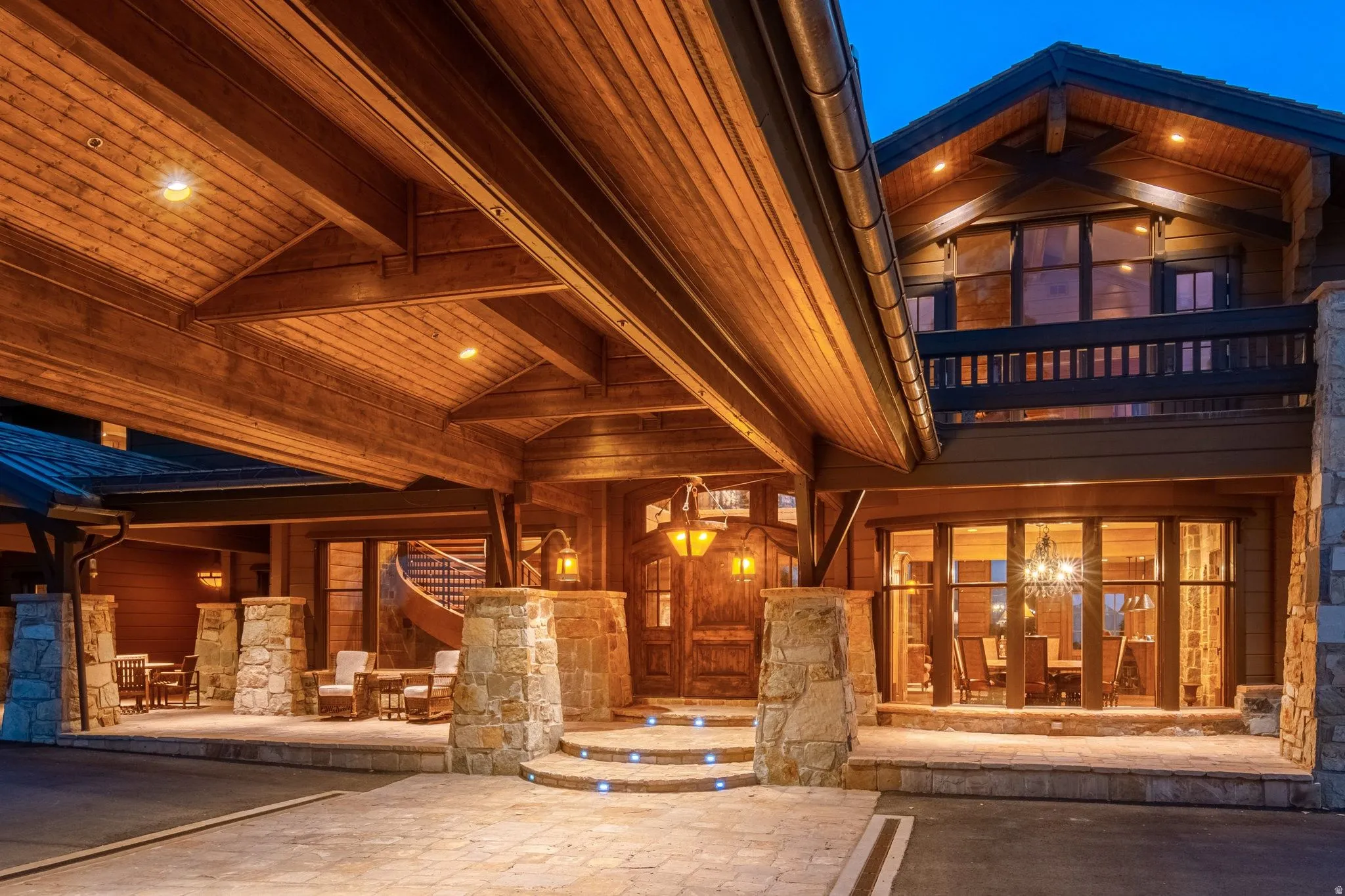 Stone and timber exterior featuring a porte-cochere with recessed lighting