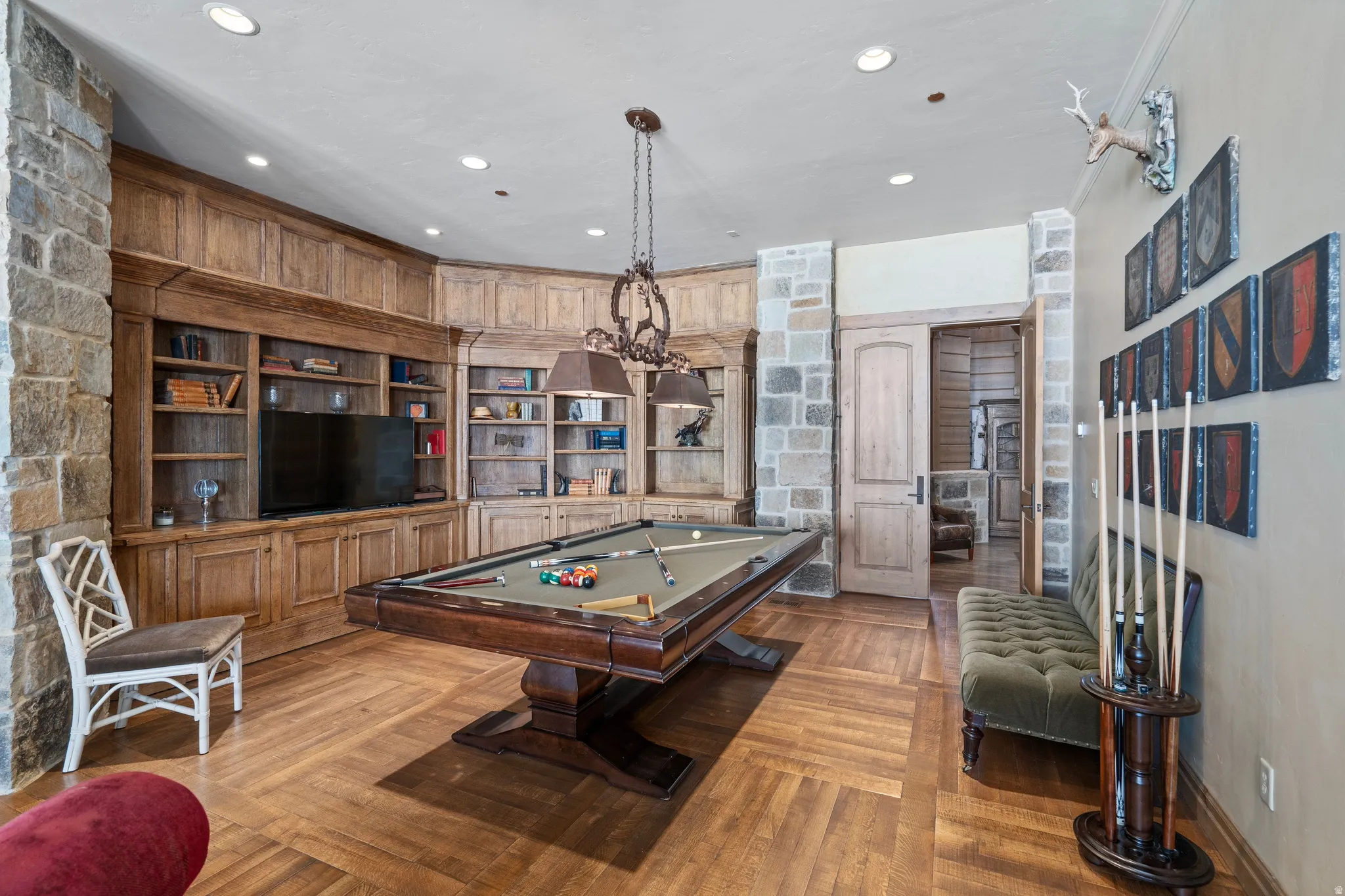 Herringbone wood-finish flooring complements the built-in wood cabinetry and shelving