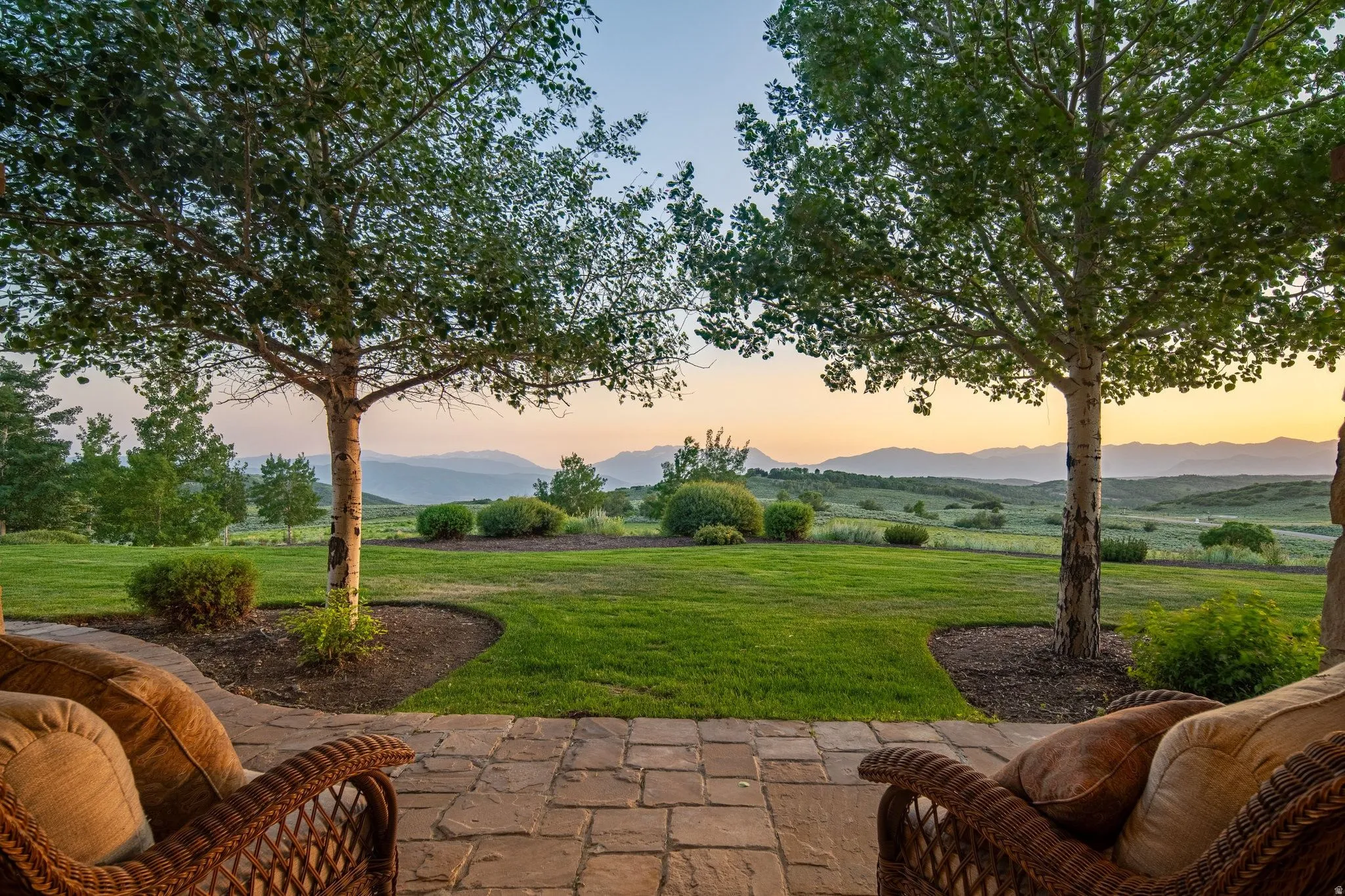 Expansive patio featuring paver flooring and direct access to a large lawn