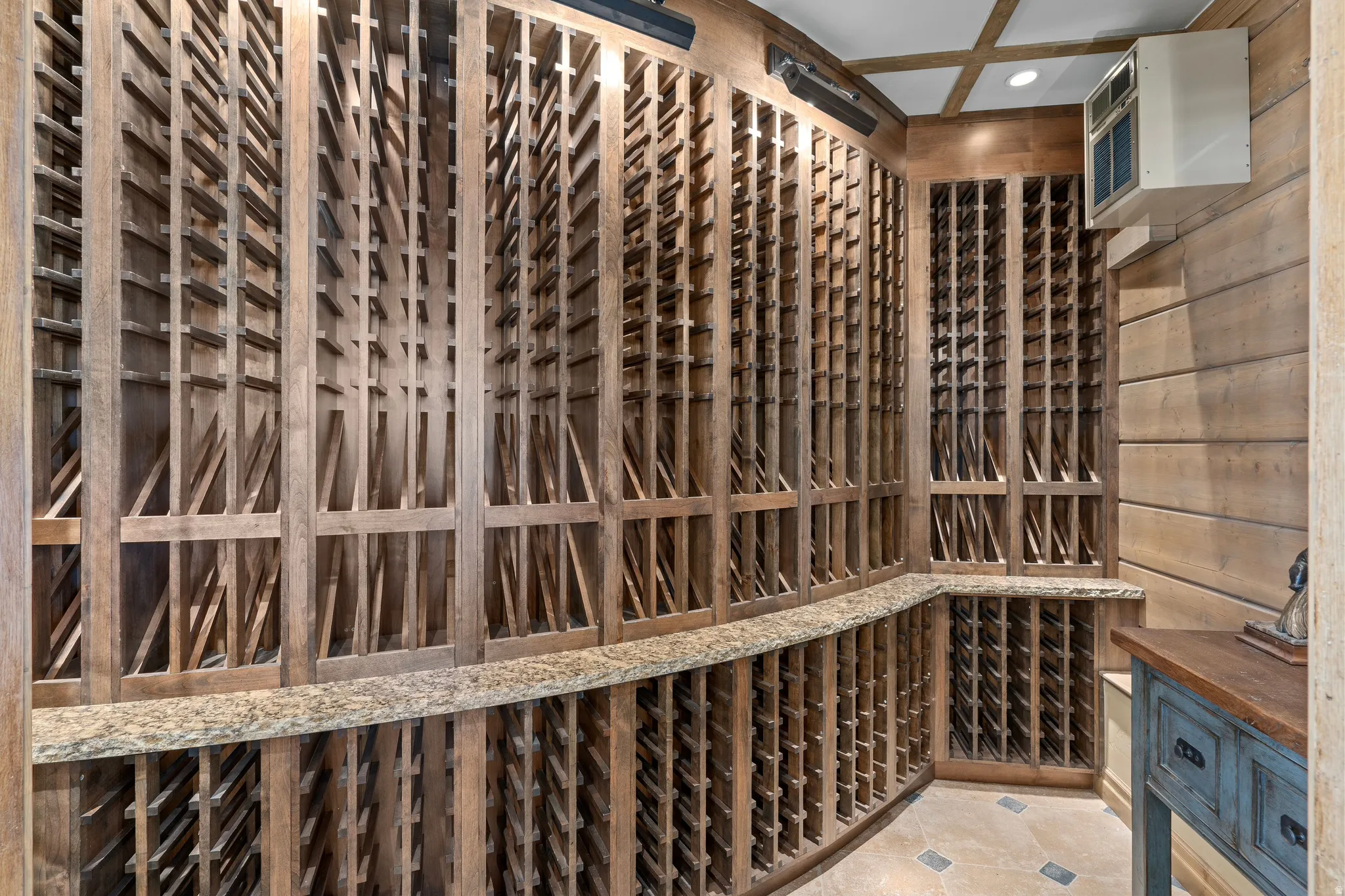 Custom wood wine racking with integrated stone-finish countertops
