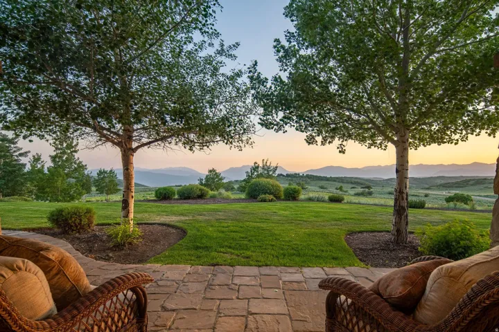 Expansive patio featuring paver flooring and direct access to a large lawn