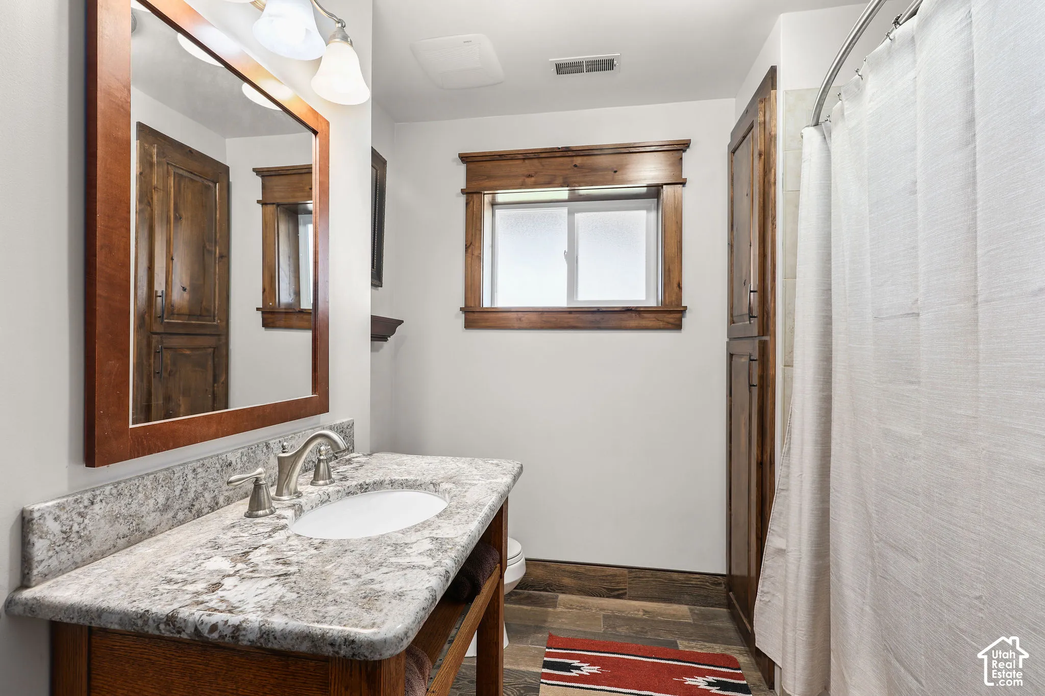 2nd Bathroom vanity featuring a light-toned countertop, undermount sink, and brushed nickel fixtures