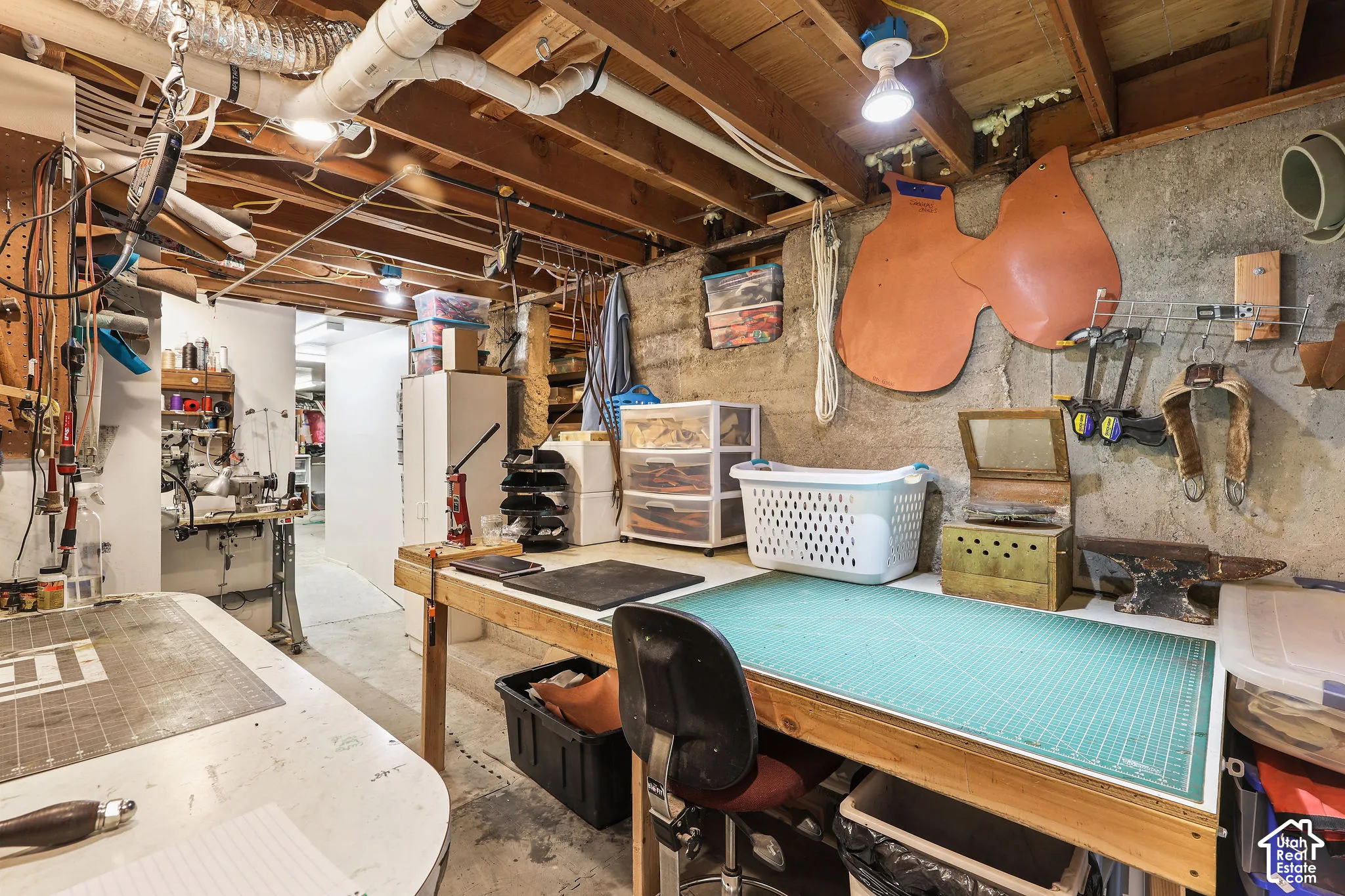 Basement utility space featuring exposed ceiling joists and plumbing