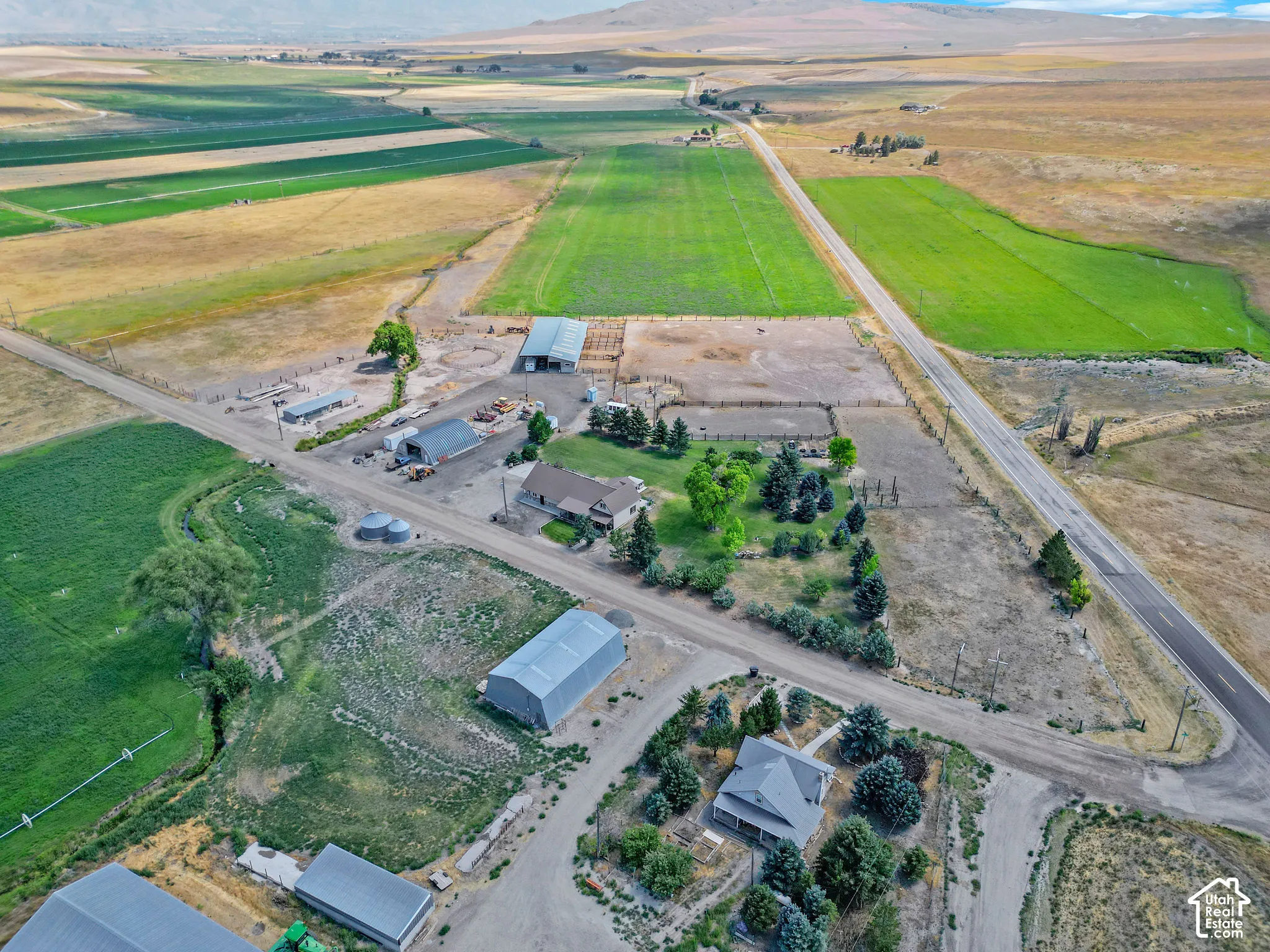 Expansive aerial view showcasing agricultural land with multiple structures