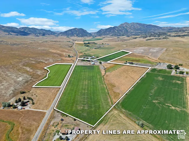 Aerial perspective showcasing extensive agricultural fields with distinct property lines
