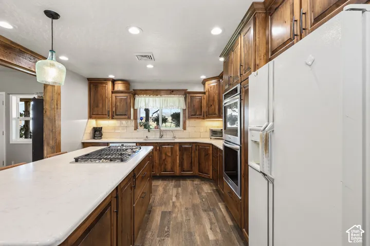 Kitchen featuring wood-finish flooring and custom wood cabinetry
