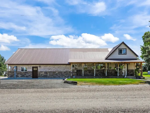 Stone facade home with a corrugated metal roof