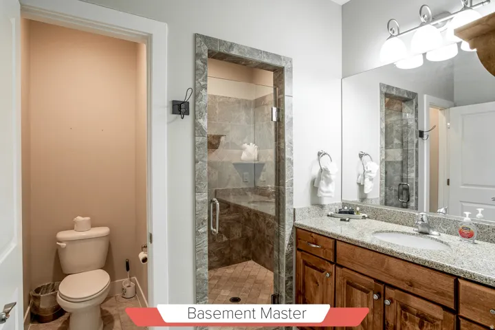 Bathroom vanity featuring a granite countertop, undermount sink, and wood cabinetry