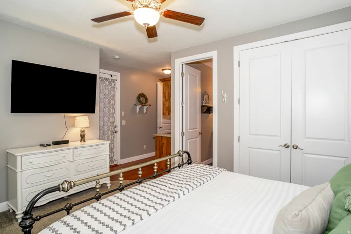 Neutral gray wall paint, wood-finish ceiling fan, and white trim