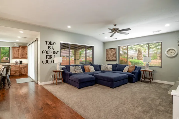 Open living area featuring wood-finish flooring, recessed lighting, and a ceiling fan