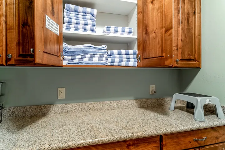 Built-in upper cabinetry with wood-finish doors and interior shelving