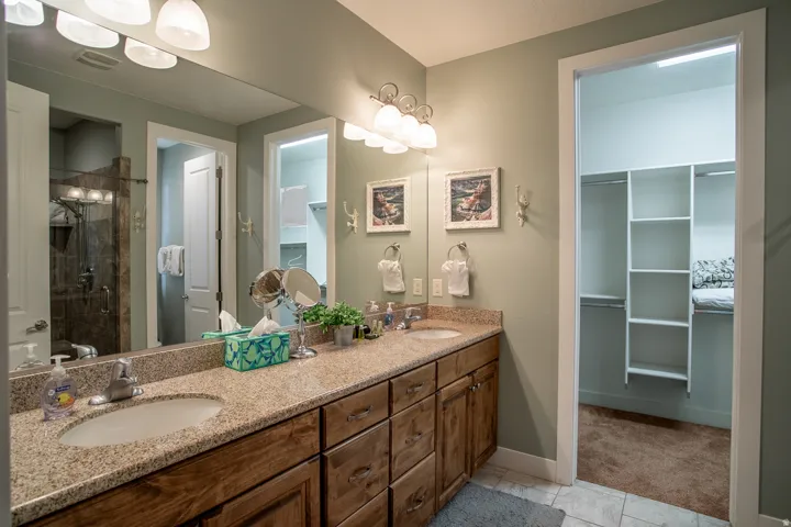 Double vanity with light-toned granite countertop and under-mount sinks