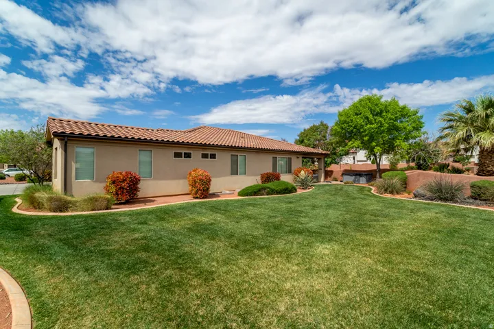 Expansive green lawn with a curved stone border