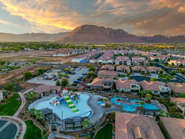 Community pool complex featuring a large recreational pool with slides and a separate resort-style pool with rock features