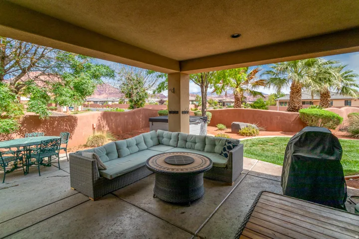 Covered patio featuring concrete flooring and stucco columns