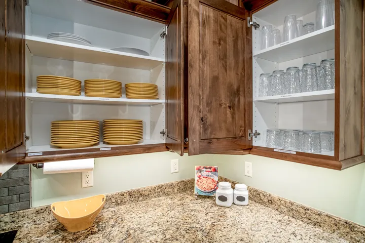 Kitchen cabinetry featuring rich wood-finish doors and bright white interiors