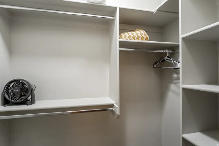 Custom closet system featuring multiple shelves and hanging rods