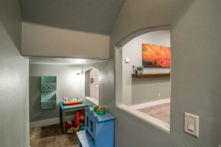 Archway featuring a wood-finish floating shelf