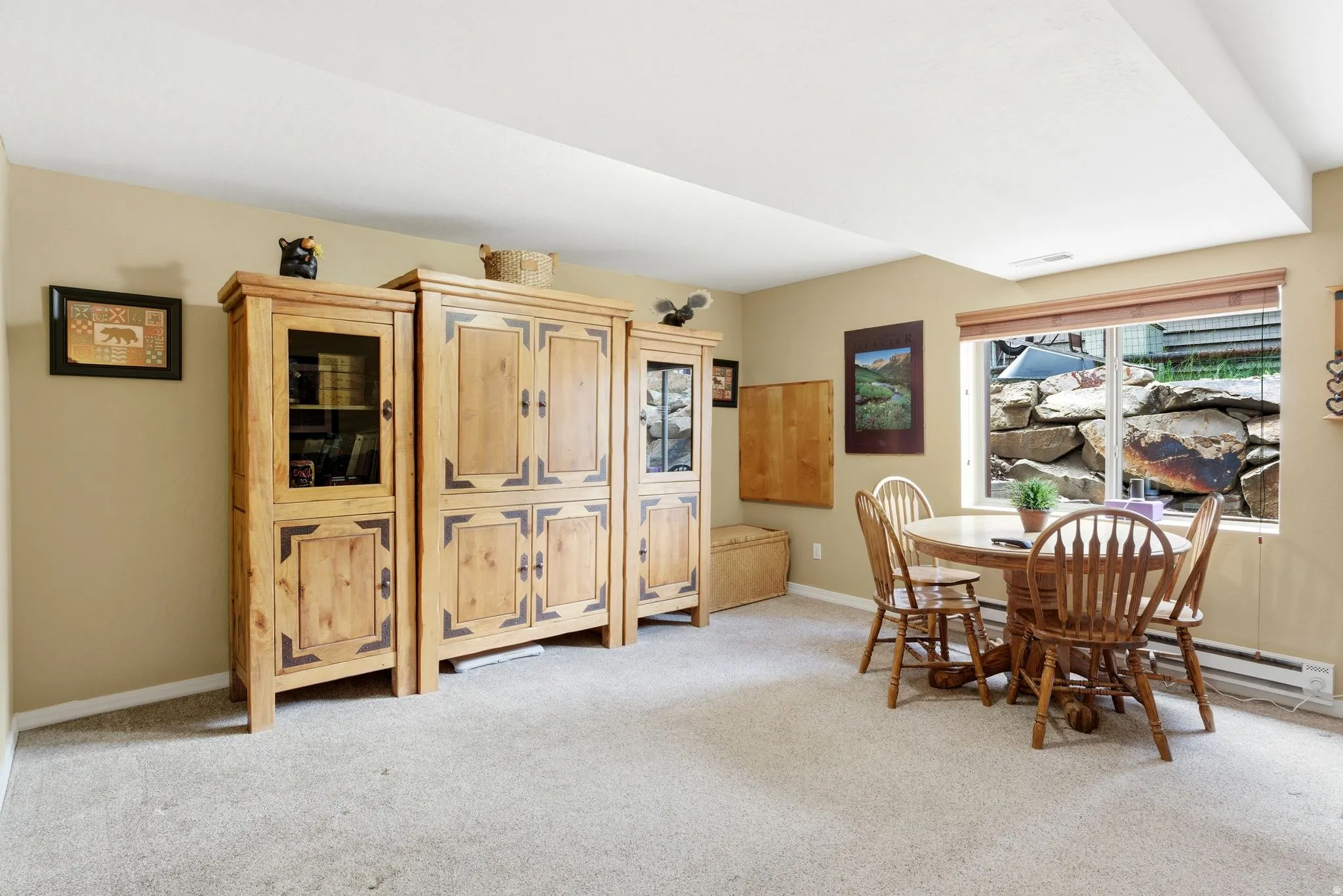 Carpeted room with a ceiling bulkhead and light beige wall paint