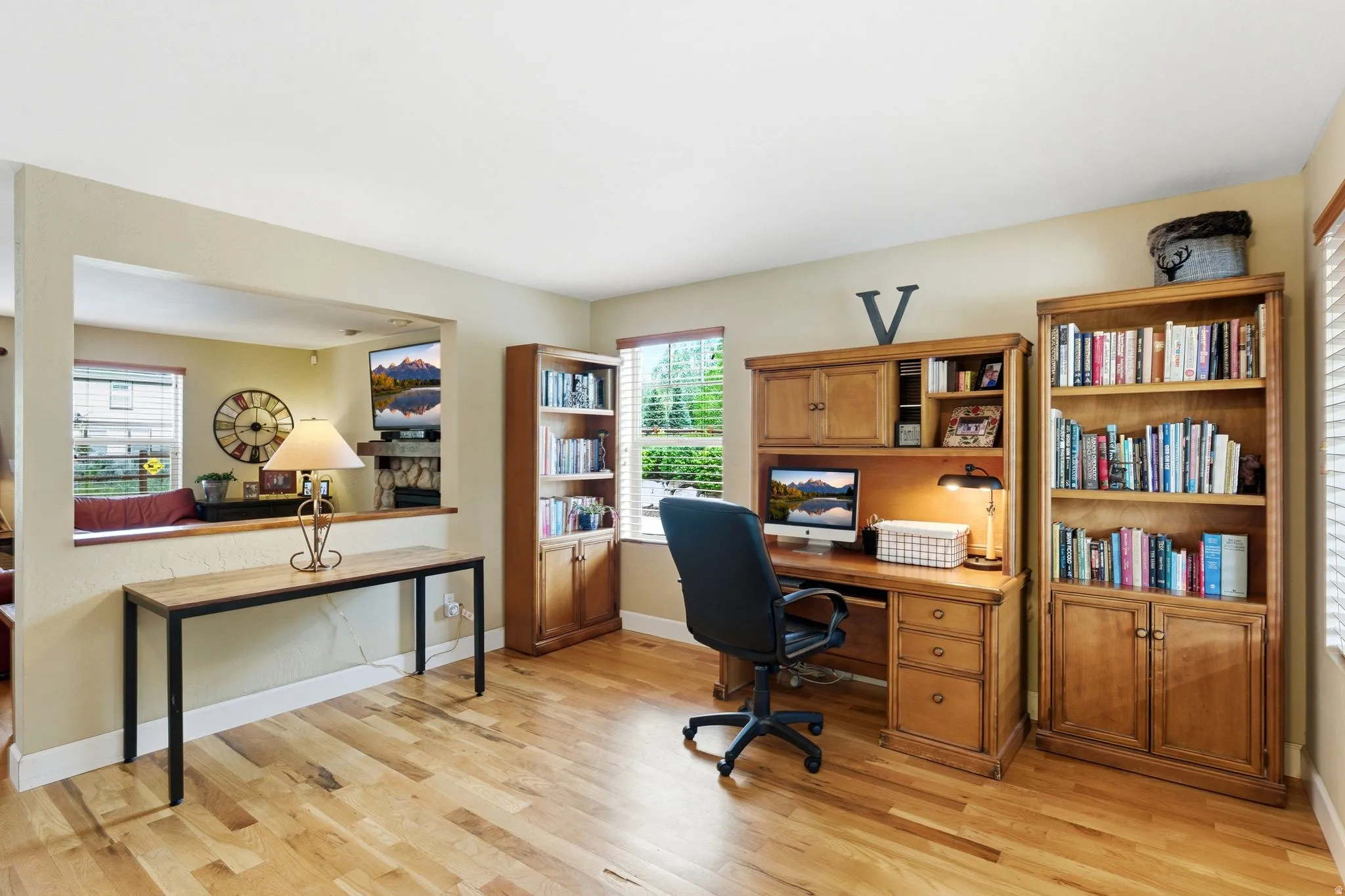 Dedicated office space featuring wood-finish flooring and multiple windows
