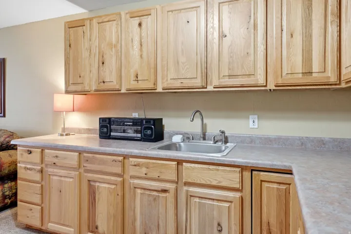 Light wood-finish cabinetry with panel doors and drawer fronts