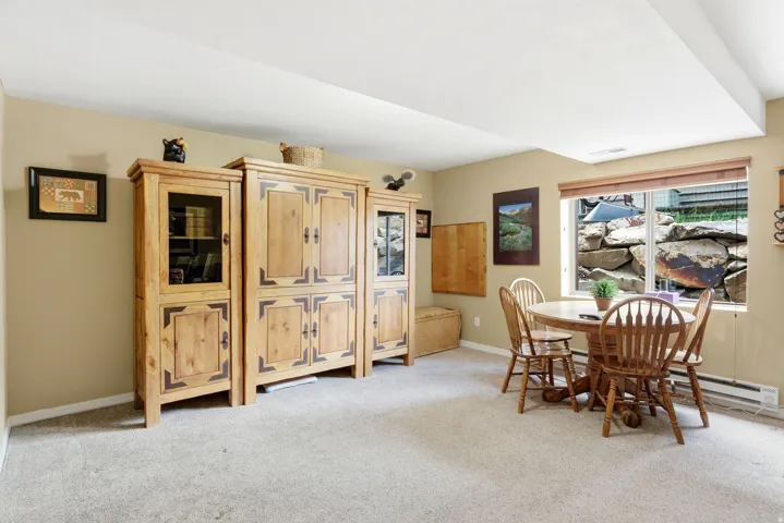 Carpeted room with a ceiling bulkhead and light beige wall paint