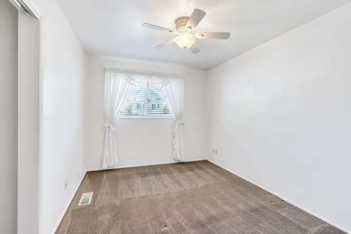 Neutral-toned carpet flooring and white walls