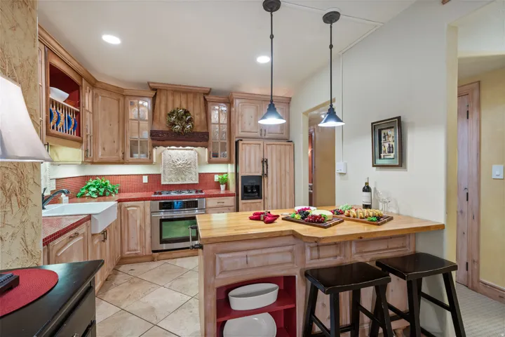 Kitchen with Custom Cabinetry and Wood Paneled Refrigerator